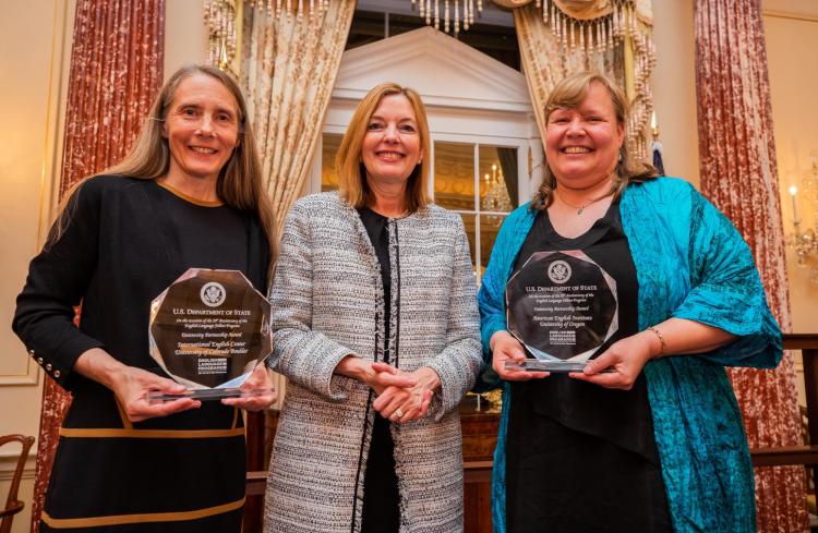 Susan Fouts, Marie Royce, Assistant Secretary of State for Education and Cultural Affairs, and Cheryl Ernst stand with their awards.